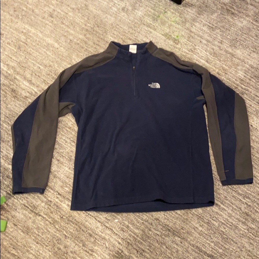 A dark blue and grey North Face quarter zip
